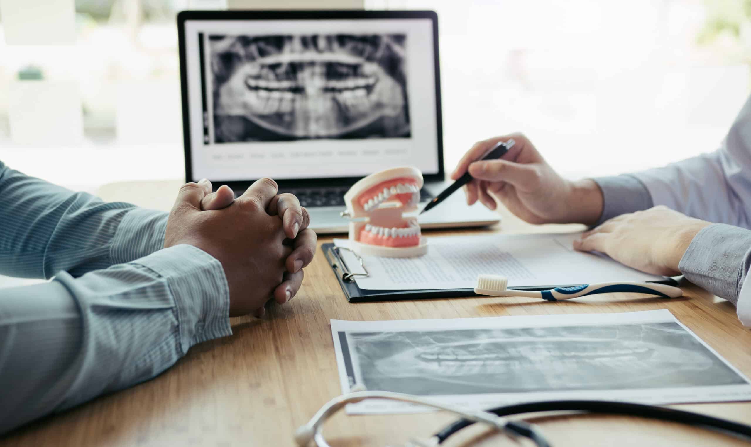 Dentists,Are,Discussing,Dental,Problems,At,Report,X-ray,Image,On