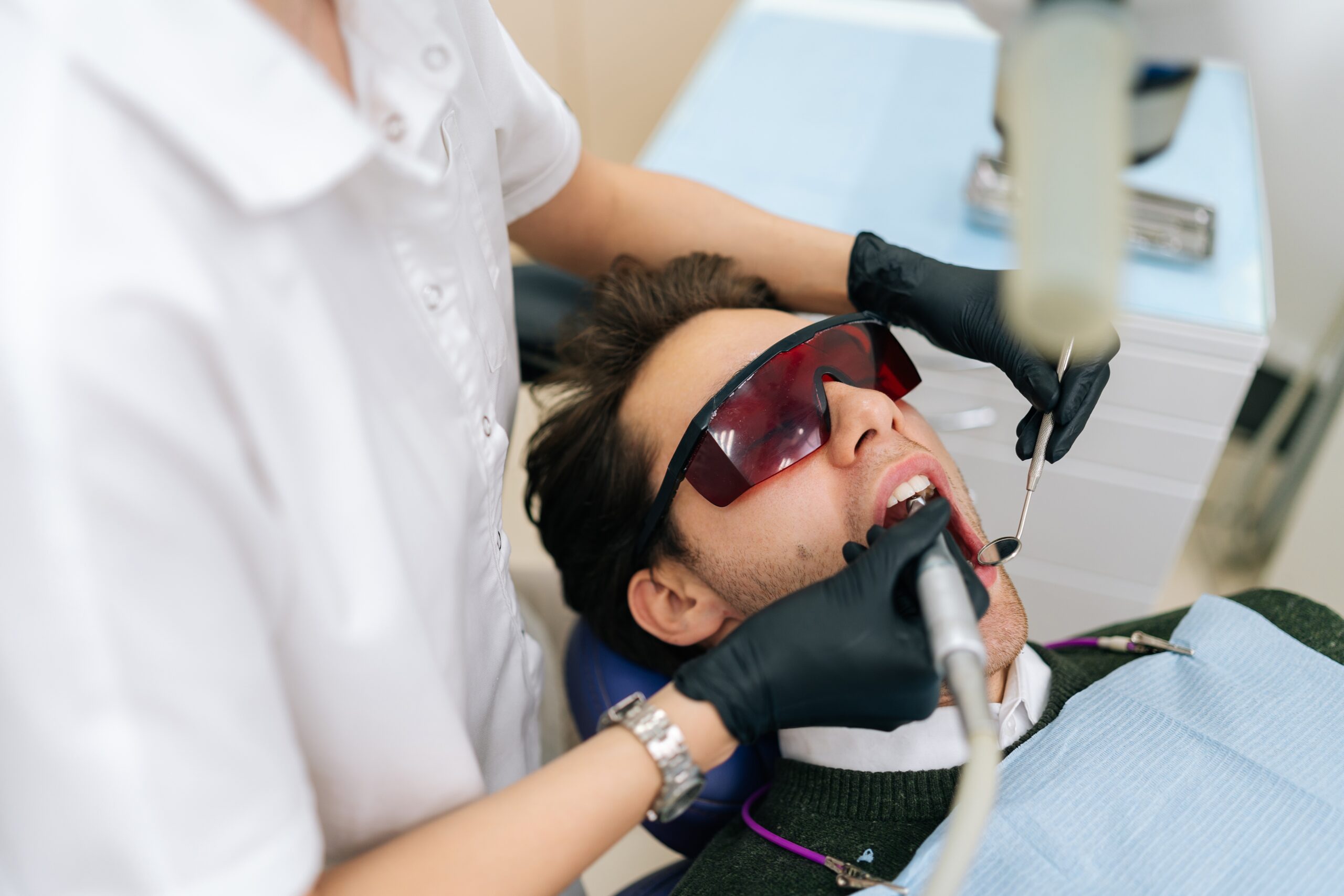 Female,Dentist,Using,Modern,Diode,Dental,Laser,For,Periodontal,Care,